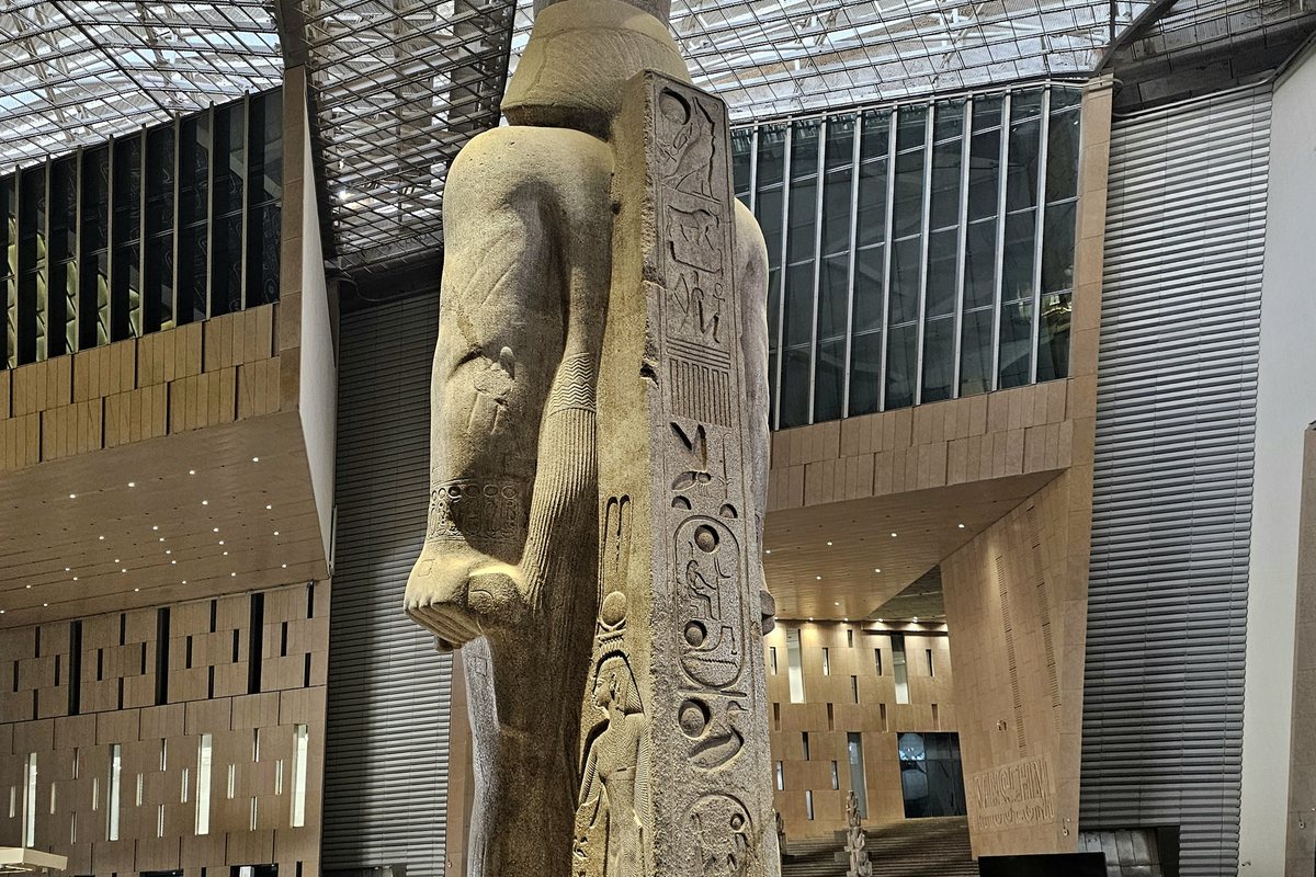 Colossal statue of Ramesses II rising through the Grand Egyptian Museum atrium